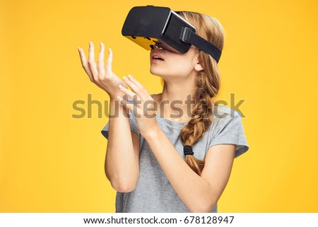 Woman in 3d glasses of virtual reality on a yellow background                               