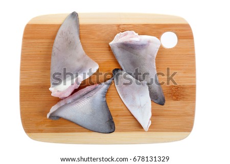 Shark fins on the cutting board. Isolated on white background