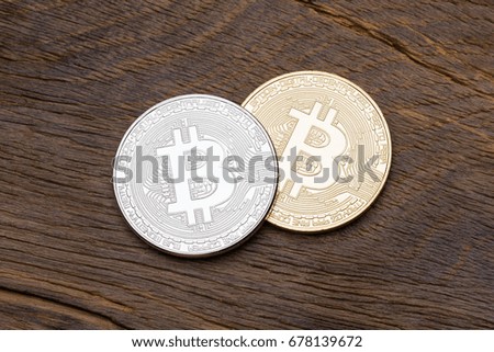 Close up of silver and golden bitcoins on wooden background, macro shot. High resolution photo.