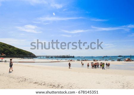 people on white beach with sea and blue sky background