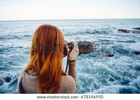 Woman taking pictures of the sea, nature, fresh air                               