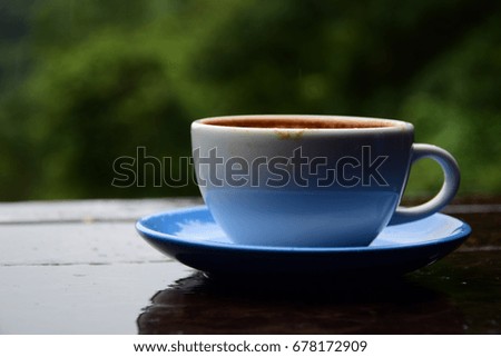 empty cup of hot latte coffee is on the wooden table with blur background, coffee lover