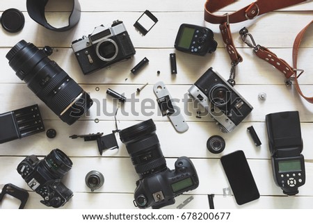 Photographer Workplace, Camera, Lenses And Accessories On White Wooden Background. Top View