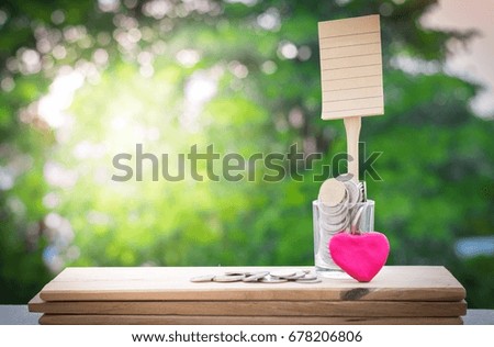 Brown paper of the book with money and heart on blur tree background. Using for note in order that education with business and life style.