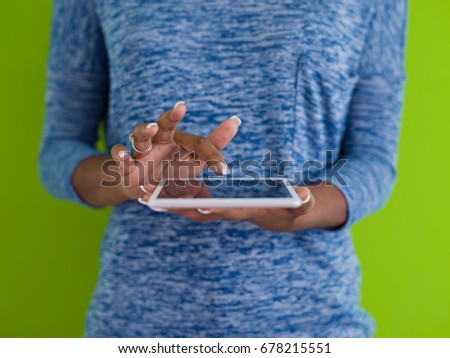 Young Happy African American Woman Using Digital Tablet  Isolated on a green background