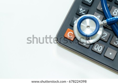 Close up of stethoscope on calculator