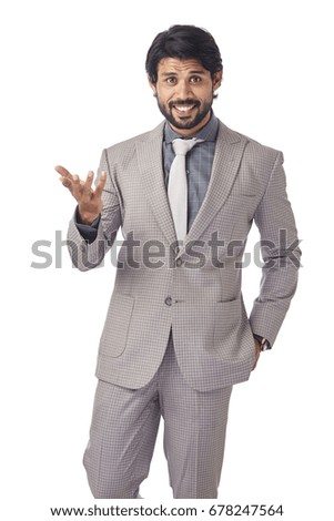 Cheerful young businessman in happy mood on white background.