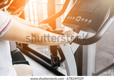 sport and health concept with asian beautiful girl exercise with equipment in fitness room