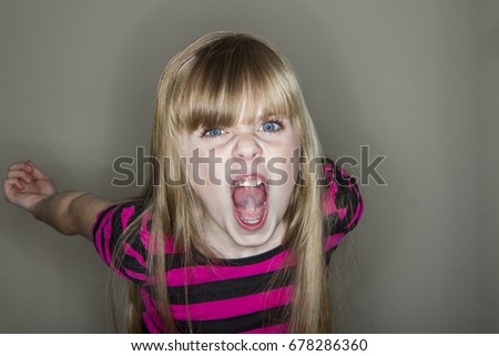 unhappy young little girl yelling Royalty-Free Stock Photo #678286360