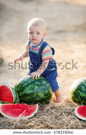 little cute boy with watermelon and slices. summer portrait of smiling happy child 