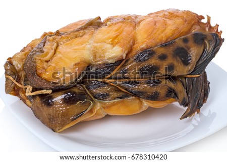 A piece of smoked catfish on a white plate