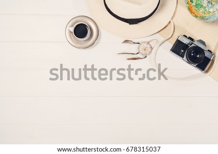 Accessories for travel top view on white wooden background with copy space. Adventure and wanderlust concept image with travel accessories. Preparing for an exotic trip, journey and sightseeing.