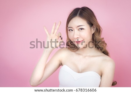 closeup beautiful korea woman show hand for accept, isolated on pink background, 20-30 year old.