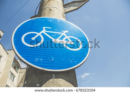 Bicycle blue round road sign on a street pillar in a neighborhood