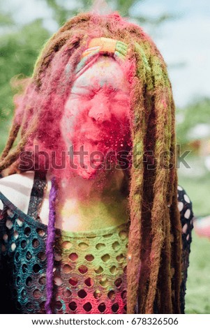 woman with long colorful dreadlocks hair at Holi festival 