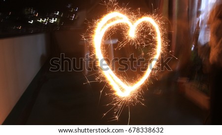 Heart shaped handy fireworks in a balcony.