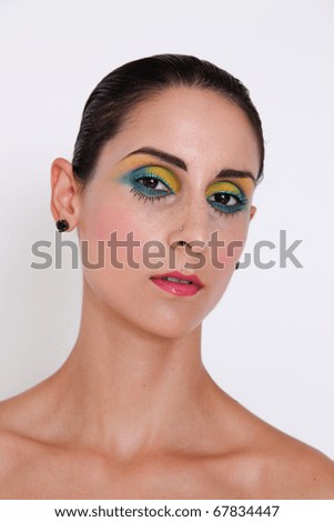 Portrait of a beautiful young brunette model with bright make-up.