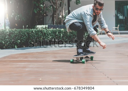 Skater boy skating longboard on the street in Bangkok