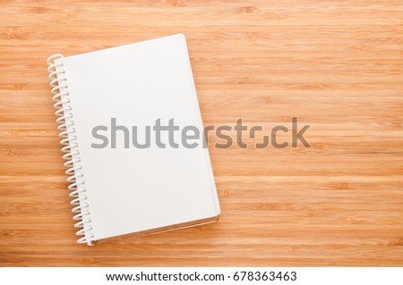 Notebook on wooden table.