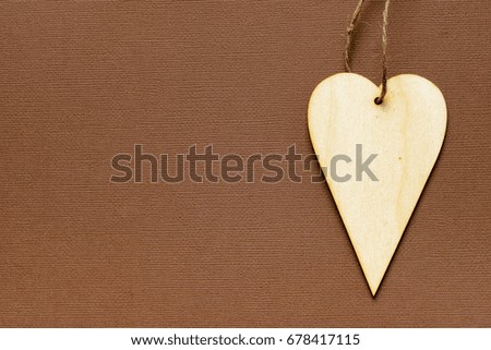 Handmade wooden heart on light background as greeting card