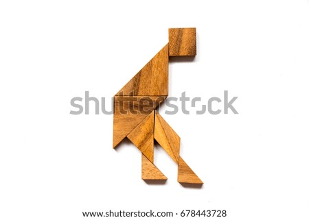 Wooden tangram puzzle in dancing man shape on white background