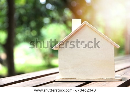 Model house on wooden table,Buying new house, real estate and home mortgage concept.