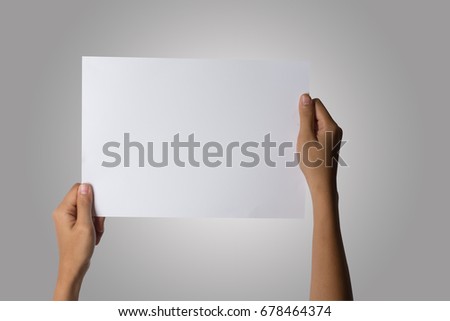 Close Up of woman hand holding blank paper isolated on white background