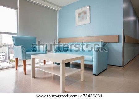Classic blue sofa decorate with picture on the wall