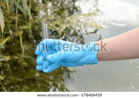 Taking a water test for analysis from a reservoir.