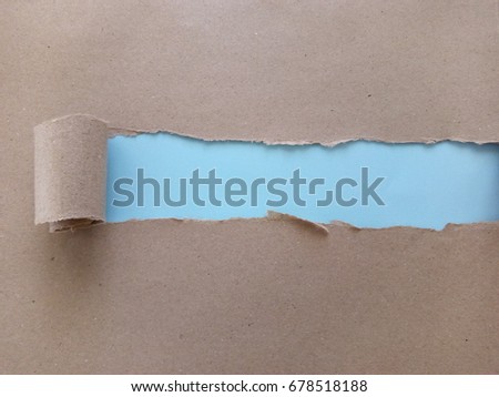 Copy space and greeting concept. Brown paper's envelope torn with copy space on light blue background. Selective focus.

