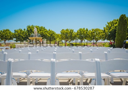 White chairs with vineyards in the blur background