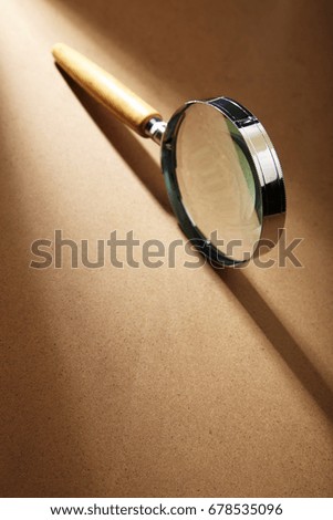 magnifier glass on the brown table top