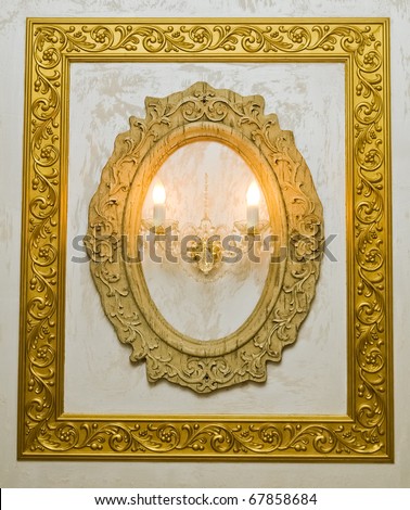 Rectangle and oval aged  frame on the wall with  two candles