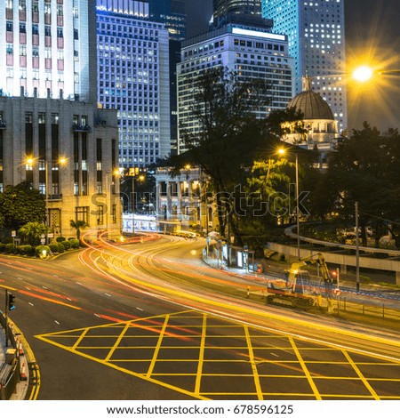 urban traffic road with cityscape in background at night in Hong Kong,China.