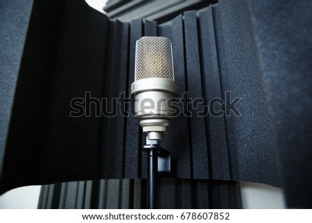 Condenser microphone on stand in a sound recording studio
