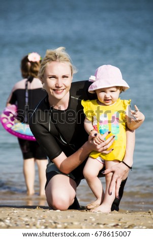 Little girl with her mother on the sea