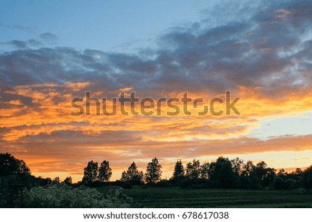 Stunning bright golden with pink sunset against the backdrop of the countryside
