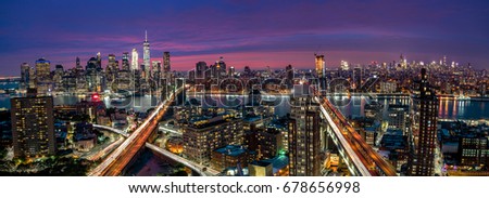 View over Manhattan and Brooklyn skyline during sunset.