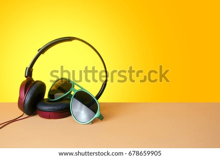 season holiday vacation recreation, headphone song music relax with fashion gadget sunglasses on yellow background in summer travel time concept, tourism decoration, colorful fun