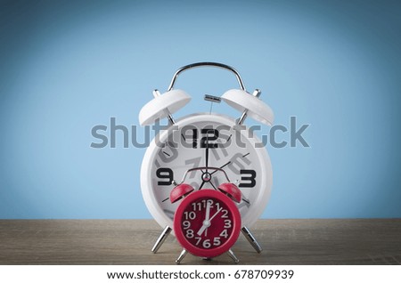 red and white alarm Clock on pastel background. with free copyspace for your creativity ideas text