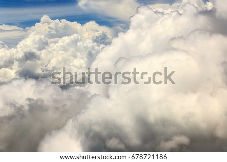 Dense Fluffy Puffs of White Clouds Blue sky at high level attitude, view from window airplane, copy space