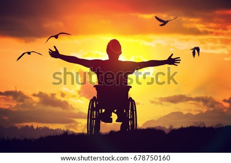 Disabled handicapped man has a hope. He is sitting on wheelchair and stretching hands at sunset. Royalty-Free Stock Photo #678750160