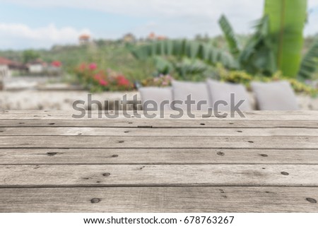 Wood table top on blurred green background - can be used for montage or display your products
