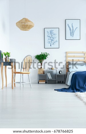 View of bright stylish bedroom in minimalist scandinavian flat
