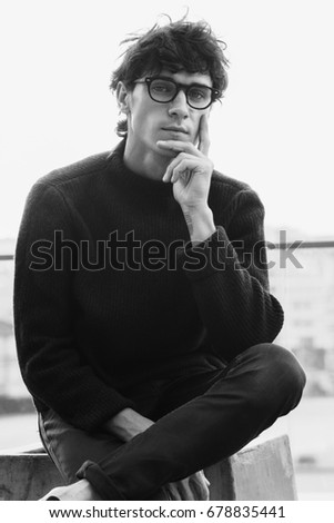 Portrait of white caucasian stylish handsome brunette young man in glasses on the sunset. Copy space. Fashion casual clothes advertisement concept. Modern young businessman. Vintage film effect. 