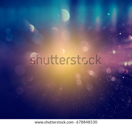 Abstract bokeh background. Defocused glitter lighting image for art and design. Zooming effect style.