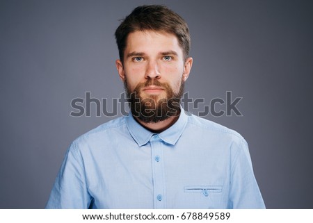 Business man with a beard on a gray background                               