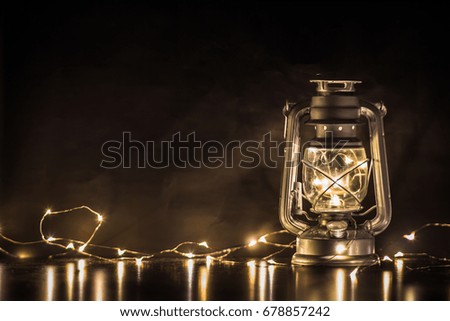 Oil Lamp and jar Light with background garland lights from led. color filter vintage tone.