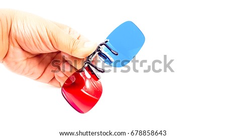 Man hand holding plastic clip of blue and red three dimensional glasses isolated
