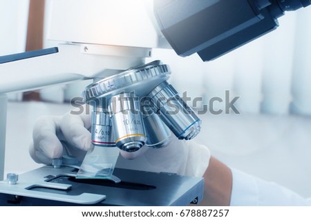 Doctor hand with microscope in laboratory room. Scientific research